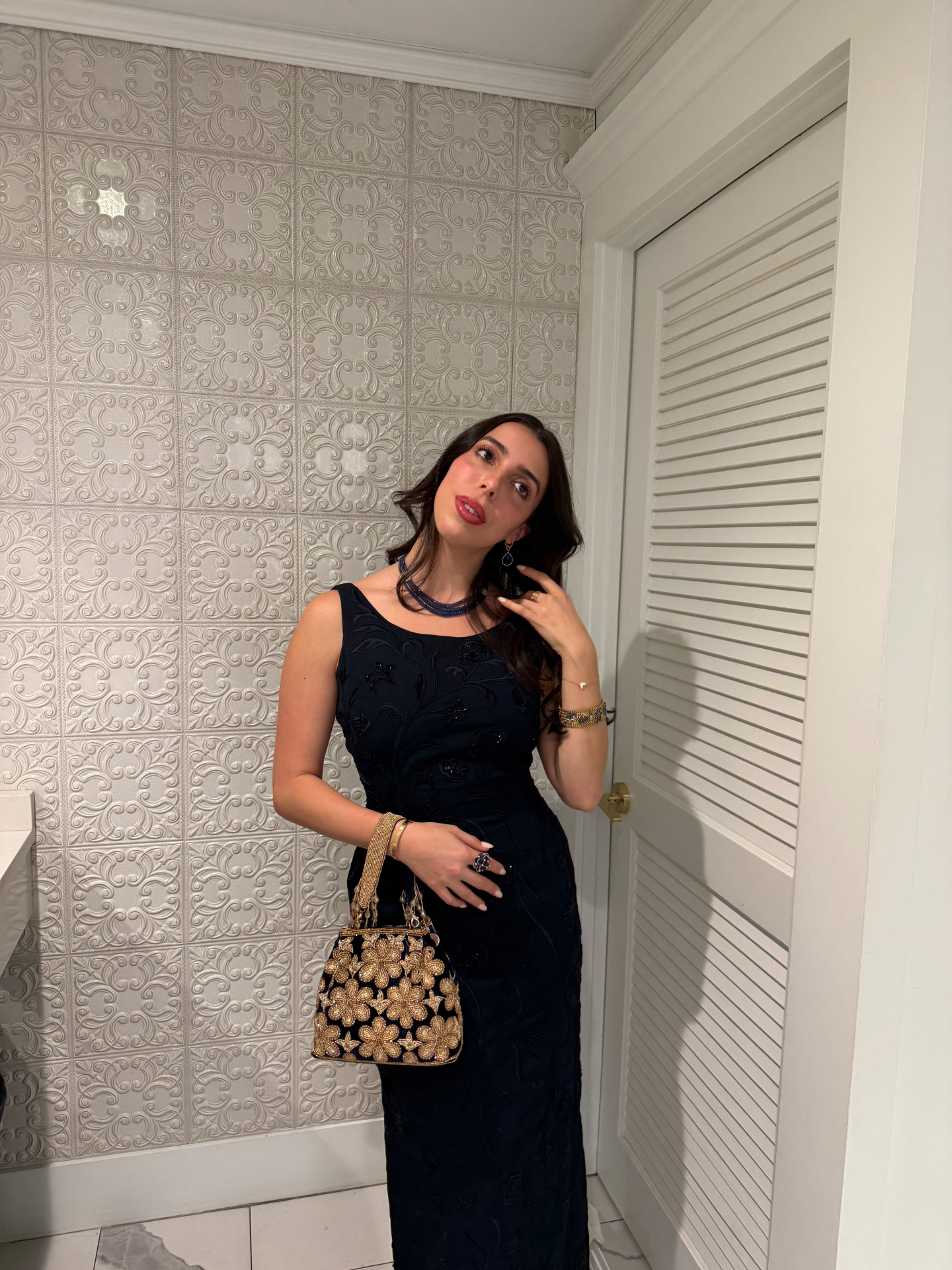 Beaded navy gown with sapphire jewelry