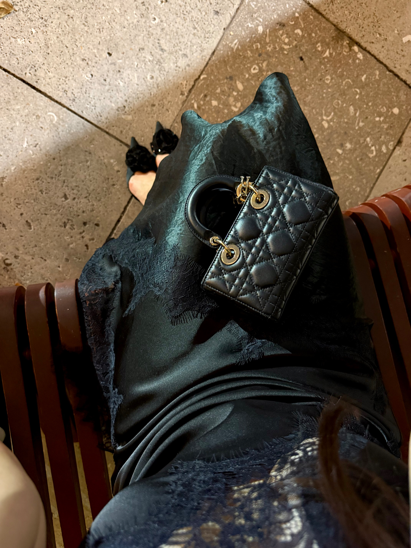 Black satin slip dress with Lady Dior bag